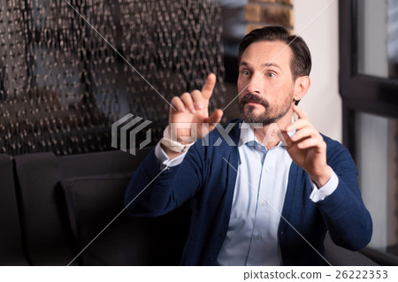 Curious bearded man working with virtual images 26222353