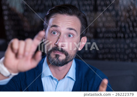 Curious handsome man touching the virtual screen Curious handsome man touching the virtual screen 26222379