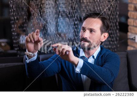 Curious handsome man using virtual sensory panel Curious handsome man using virtual sensory panel 26222380