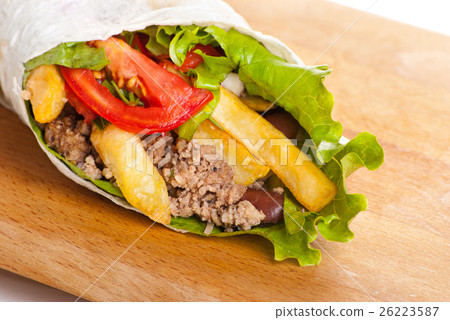 beef burrito with peppers, fried potato and tomato 26223587