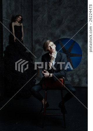 Fashion man sitting on a chair in room and dreaming. Fashion man sitting on a chair in room and dreaming. 26224478