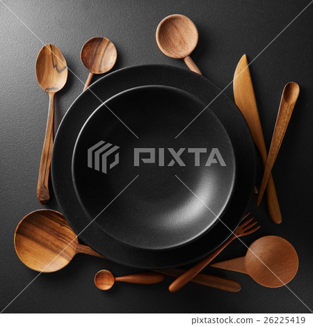 two plates and wooden cutlery 26225419