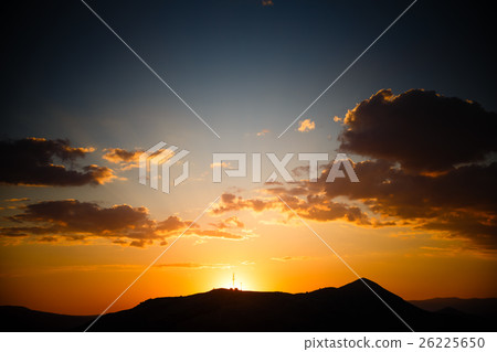 Sunset landscape with golden sunlight above silhouette of mounta 26225650