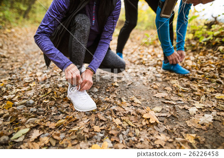 Unrecognizable runners in nature, tying shoelaces 26226458