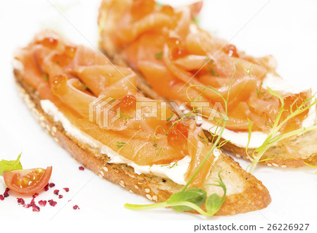 Sandwiches with salmon caviar and greens adorned Sandwiches with salmon caviar and greens adorned 26226927