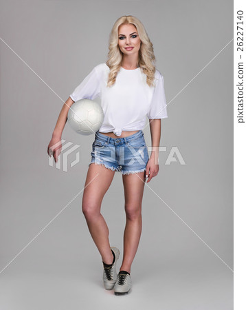 young woman holding soccer ball on her hand young woman holding soccer ball on her hand 26227140