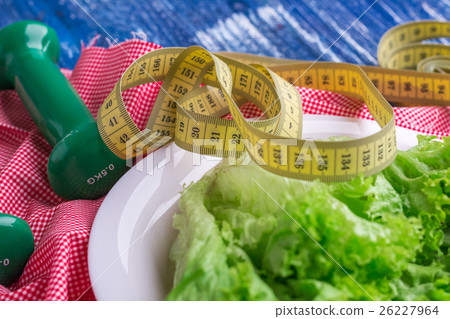 Fitness food of green lettuce, weights and ruler Fitness food of green lettuce, weights and ruler 26227964