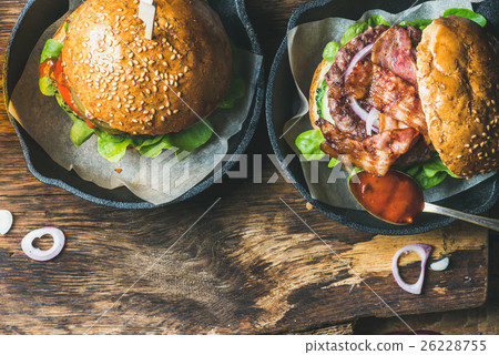 Homemade beef burgers with crispy bacon and Homemade beef burgers with crispy bacon and 26228755