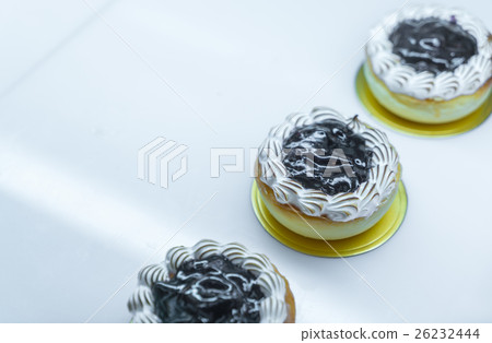 Brightly colored cakes in refrigerator . Brightly colored cakes in refrigerator . 26232444