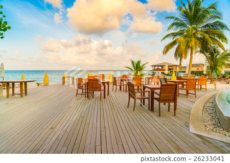 Table and chairs at restaurant in tropical Maldives island . Table and chairs at restaurant in tropical Maldives island . 26233041