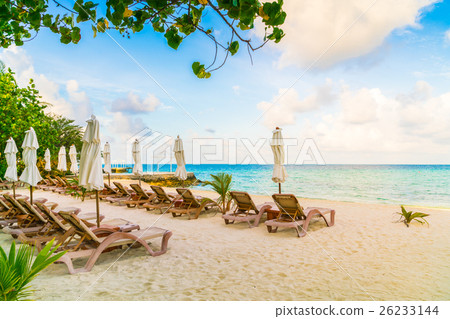 Beach chairs with umbrella at Maldives island, white sandy beach and sea . Beach chairs with umbrella at Maldives island, white sandy beach and sea . 26233144