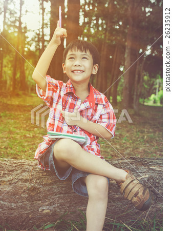 Happy asian child smiling on wooden log. Vintage. 26235912