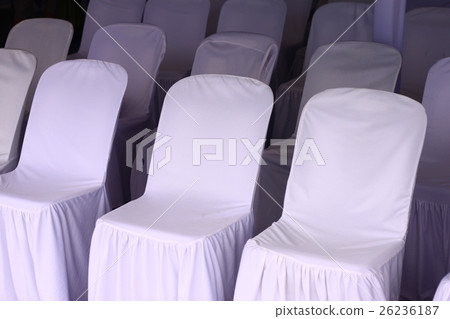 Into a chair covered with a white cloth on the mat 26236187