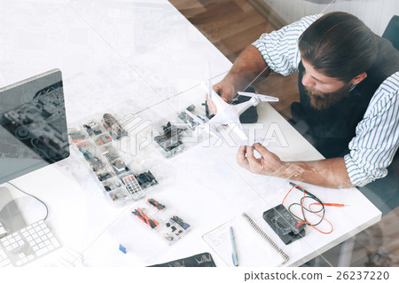 Top view on repairman with drone, double exposure Top view on repairman with drone, double exposure 26237220