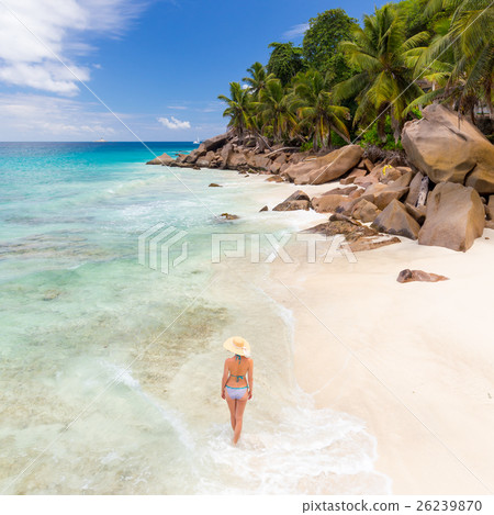 Woman enjoying Anse Patates picture perfect beach Woman enjoying Anse Patates picture perfect beach 26239870