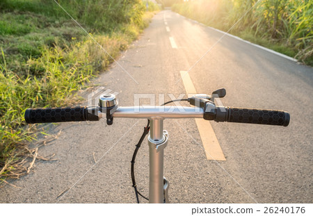 Front handle bar stem biking on rural road Front handle bar stem biking on rural road 26240176