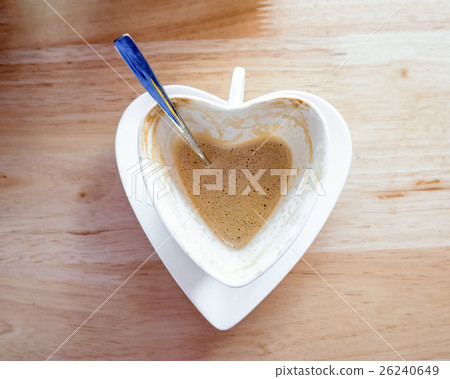 Hot coffee fade and spoon in white heart cup Hot coffee fade and spoon in white heart cup 26240649