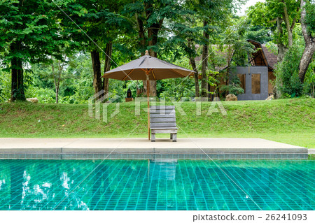 Wooden sunbed with umbrella on modern pool Wooden sunbed with umbrella on modern pool 26241093
