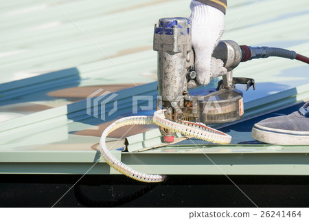Work of hitting a nail with a nail gun on a roof galvalume steel sheet Work of hitting a nail with a nail gun on a roof galvalume steel sheet 26241464