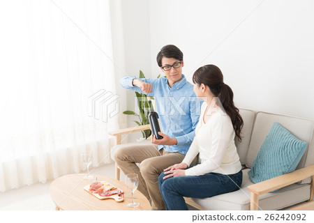 A couple drinking wine 26242092
