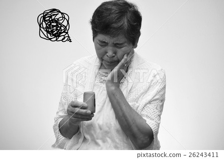 A woman in her 60's who is suffering from eating sweets 26243411