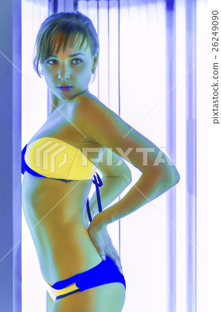 Slim woman in solarium getting sun tan Slim woman in solarium getting sun tan 26249090