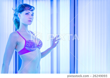 Slim woman in solarium getting sun tan Slim woman in solarium getting sun tan 26249093