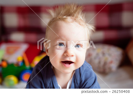 Little baby boy with spiky hair crawling on bed. Little baby boy with spiky hair crawling on bed. 26250408