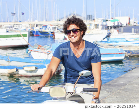 Young Italian Man on Vespa Scooter Smiling Young Italian Man on Vespa Scooter Smiling 26251034