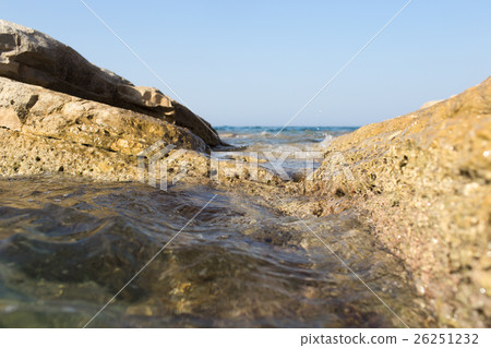 View through the rocks in an endless sea 26251232