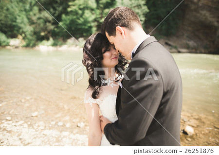 Beautifull wedding couple kissing and embracing Beautifull wedding couple kissing and embracing 26251876