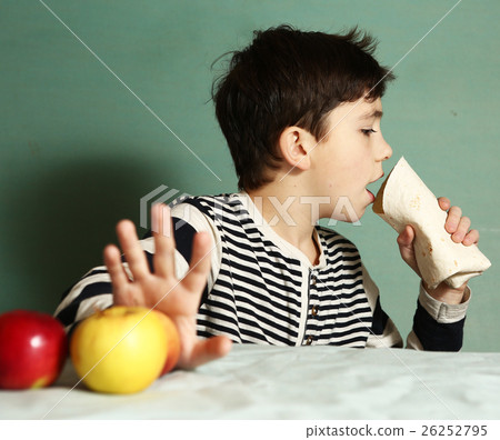 boy choosing junk food roll refuse from apple boy choosing junk food roll refuse from apple 26252795