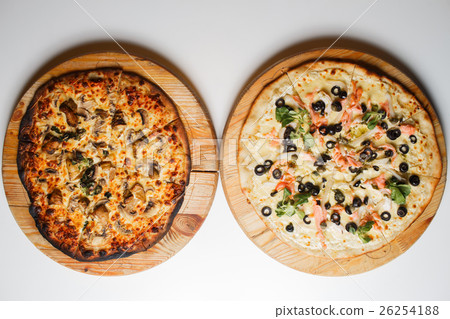 Burnt and normal two pizza with tomatoes, salami 26254188