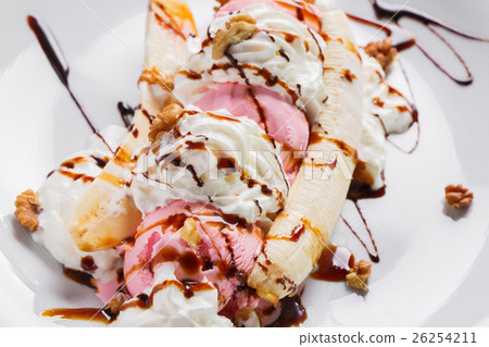 Banana split ice cream with whipped , nuts and 26254211