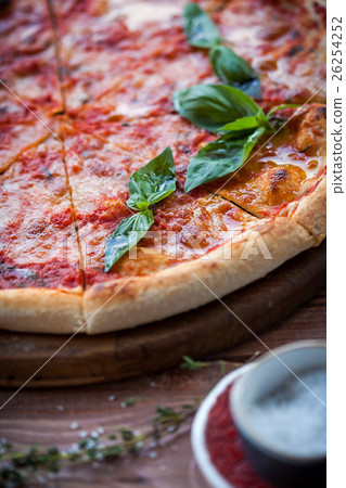 Italian pizza with basil leaves Italian pizza with basil leaves 26254252