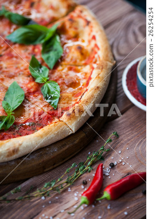 Italian pizza with basil leaves Italian pizza with basil leaves 26254254