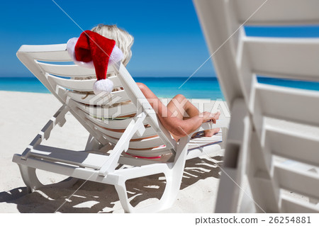 Happy woman in Santa Helper Hat lie on sunbed 26254881
