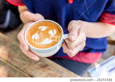hand holding coffee cup above wooden table, hand holding coffee cup above wooden table, 26255486
