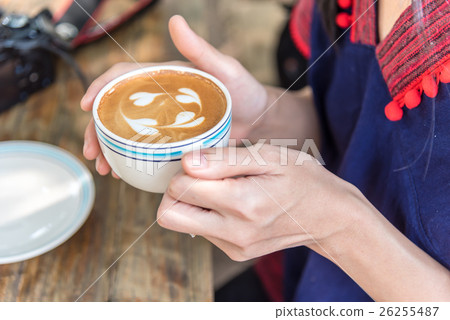 hand holding coffee cup above wooden table, hand holding coffee cup above wooden table, 26255487