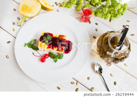 Cheesecake with red topping and tea, top view 26259444