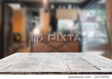Wood table top on blur background of coffee shop Wood table top on blur background of coffee shop 26259958