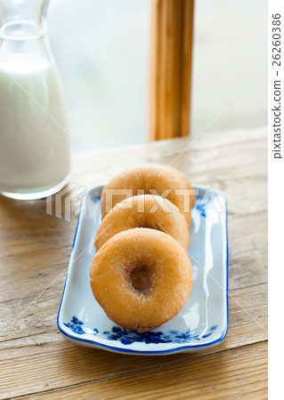 Donuts on a rectangular plate with blue ornament  26260386