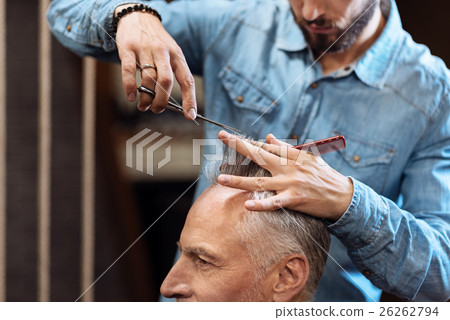Closeup of senior man having haircut in barbershop Closeup of senior man having haircut in barbershop 26262794