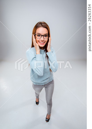 The smiling young business woman on gray The smiling young business woman on gray 26263354