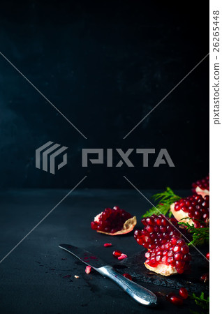 Half pomegranate and  seeds  a branch of spruce 26265448