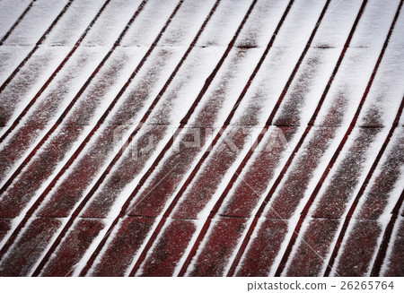 red metal roof dusted with snow 26265764