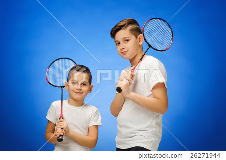 The two boys with badminton rackets outdoors The two boys with badminton rackets outdoors 26271944