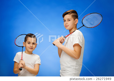 The two boys with badminton rackets outdoors The two boys with badminton rackets outdoors 26271949