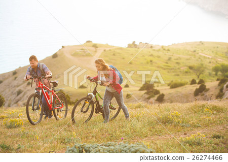 young couple  riding bikes in the mountains 26274466