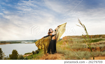 Girl dancing with golden wings. 26279709